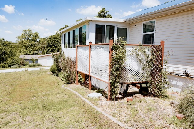 21246 County Road 295, Hermitage, MO 65668 - view of home's exterior with a sunroom and a lawn