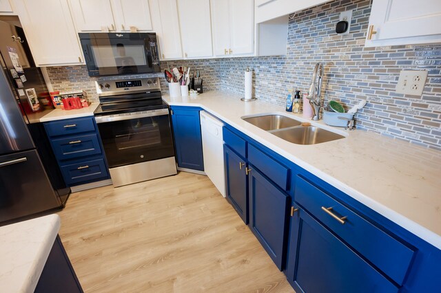 21246 County Road 295, Hermitage, MO 65668 - kitchen featuring black appliances, blue cabinetry, a sink, white cabinetry, and tasteful backsplash
