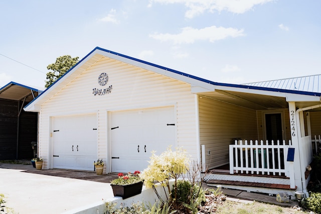 21246 County Road 295, Hermitage, MO 65668 - view of side of home featuring a garage and a porch