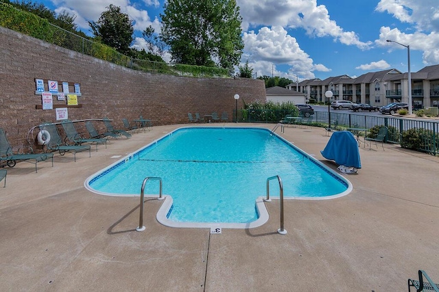 351 S Wildwood Dr Unit 3-2, Branson, MO 65616 - community pool with fence, a patio area, and a residential view