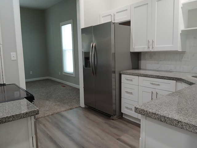 639 W Webster St, Springfield, MO 65802 - kitchen featuring stainless steel fridge with ice dispenser, open shelves, white cabinetry, wood finished floors, and baseboards