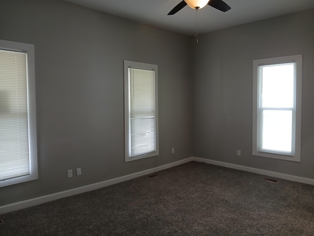639 W Webster St, Springfield, MO 65802 - spare room with ceiling fan, dark carpet, and baseboards
