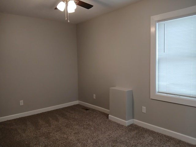 639 W Webster St, Springfield, MO 65802 - spare room with ceiling fan, dark carpet, and baseboards