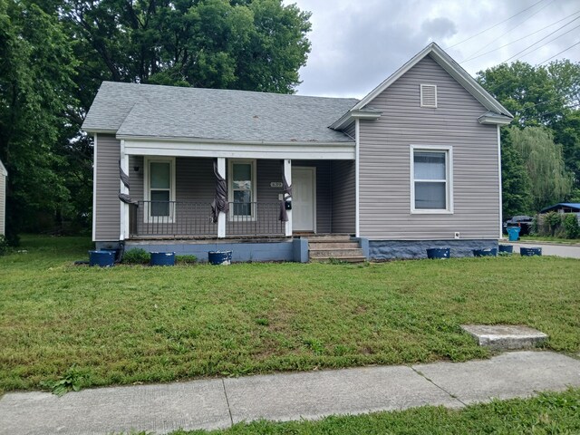 639 W Webster St, Springfield, MO 65802 - view of front of home with a porch, a front lawn, and roof with shingles