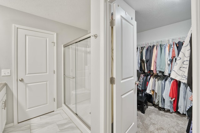 358 W Granada St, Republic, MO 65738 - full bath with a textured ceiling, a stall shower, marble finish flooring, and a walk in closet