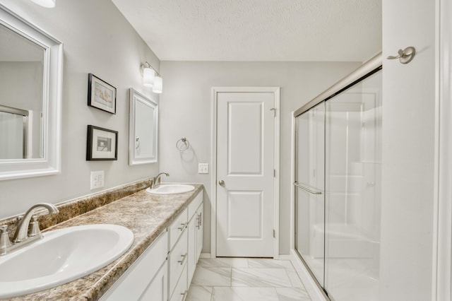 358 W Granada St, Republic, MO 65738 - bathroom featuring marble finish floors, a shower stall, double vanity, and a textured ceiling