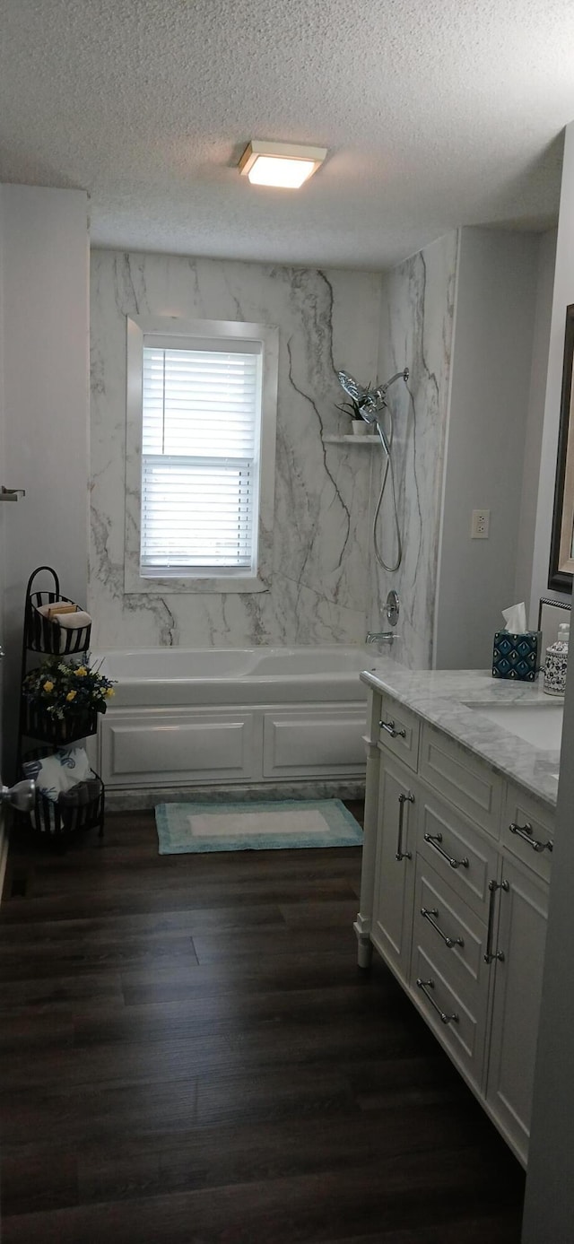 95 Starboard Dr, Kimberling City, MO 65686 - bathroom featuring a textured ceiling, vanity, wood finished floors, and shower / washtub combination