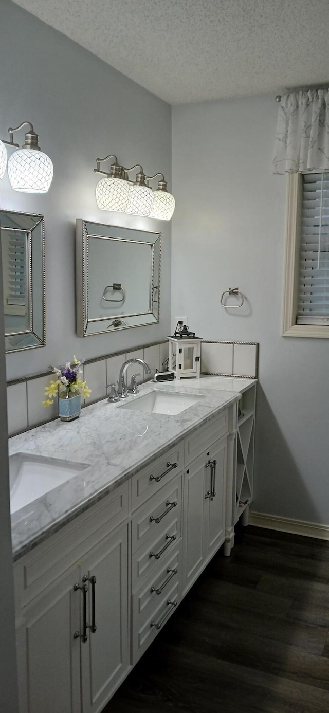 95 Starboard Dr, Kimberling City, MO 65686 - bathroom featuring wood finished floors, double vanity, a textured ceiling, and baseboards