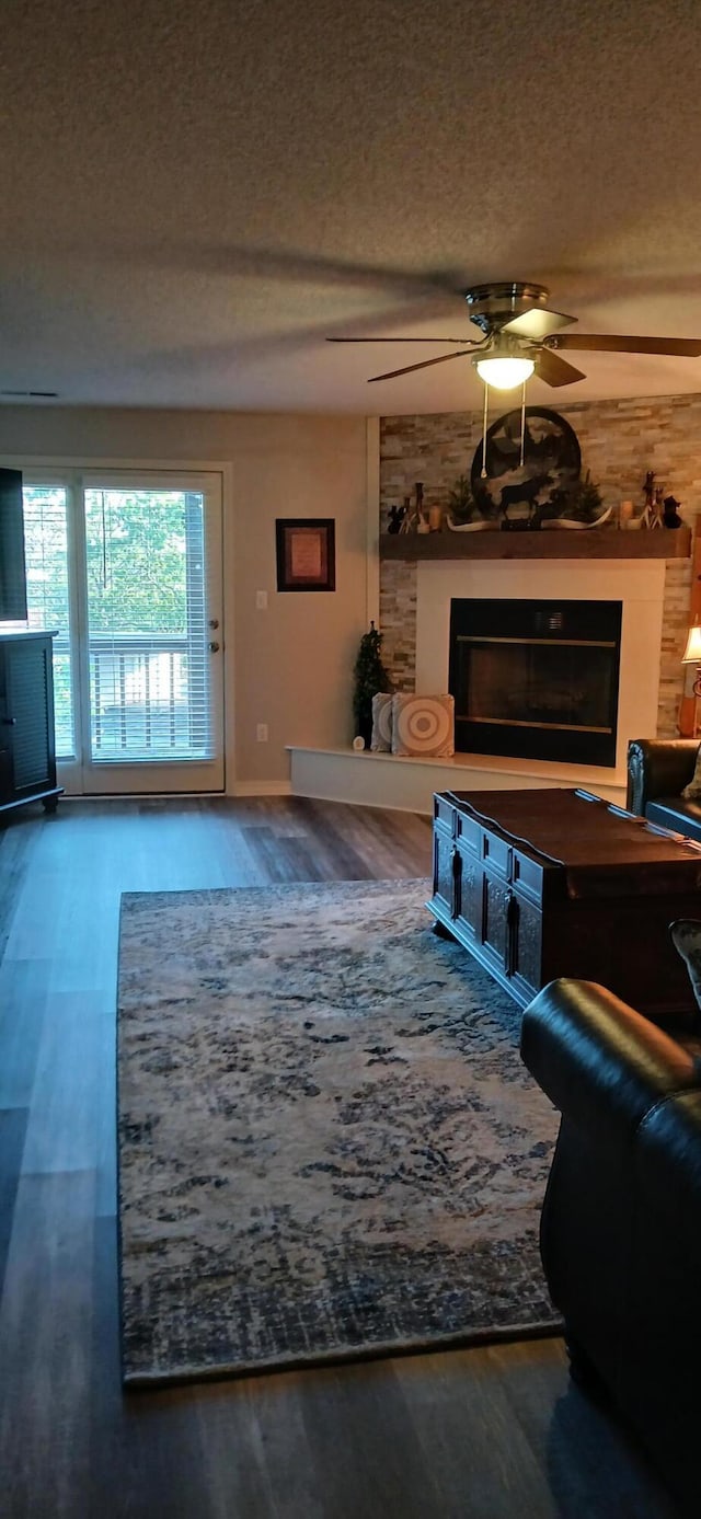95 Starboard Dr, Kimberling City, MO 65686 - living room with a large fireplace, a textured ceiling, wood finished floors, and a ceiling fan