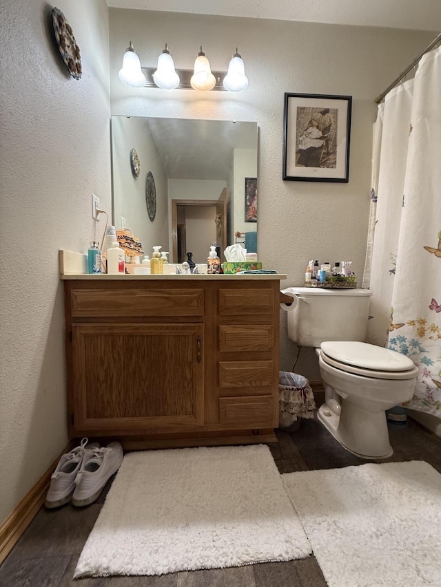 310 Mulling Dr, Highlandville, MO 65669 - full bath featuring toilet, vanity, baseboards, a textured wall, and a shower with shower curtain