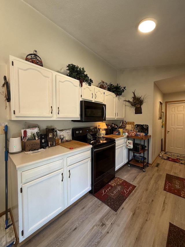310 Mulling Dr, Highlandville, MO 65669 - kitchen featuring black appliances, light wood-style floors, white cabinetry, and light countertops