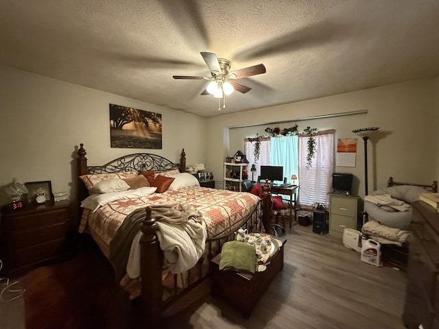 310 Mulling Dr, Highlandville, MO 65669 - bedroom with wood finished floors, an office area, ceiling fan, and a textured ceiling