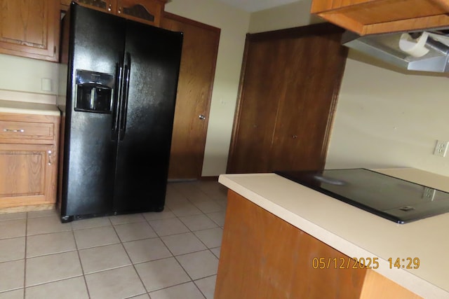 127 Grand Prairie Dr, Willard, MO 65781 - kitchen with black fridge, light countertops, and light tile patterned floors