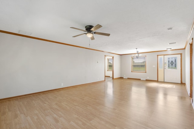 spare room featuring ornamental molding, light wood finished floors, ceiling fan, and baseboards