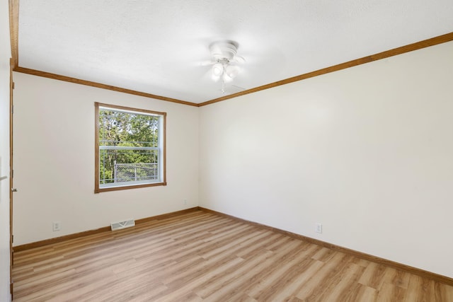 empty room with light wood-style floors, ceiling fan, baseboards, and ornamental molding