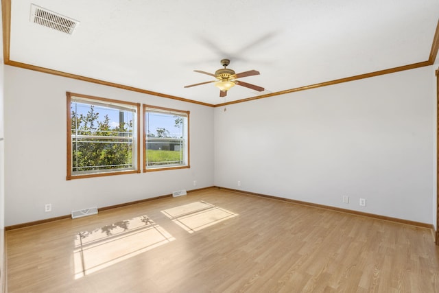 unfurnished room featuring ornamental molding, ceiling fan, baseboards, and light wood-type flooring