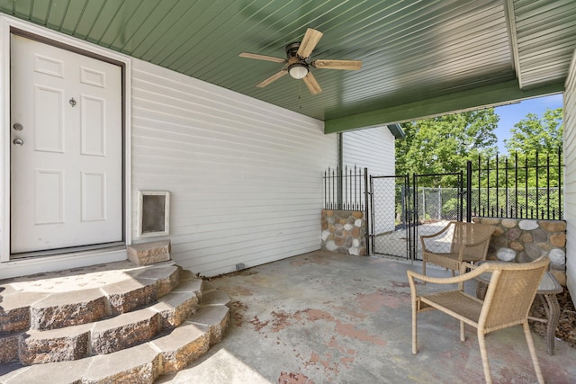 view of patio / terrace with a ceiling fan, a gate, and fence