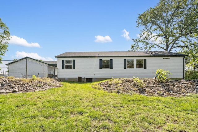 back of house with a yard and crawl space