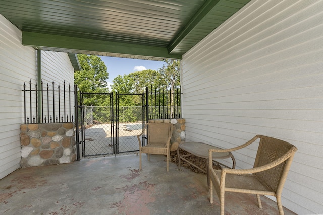 view of patio with a gate and fence