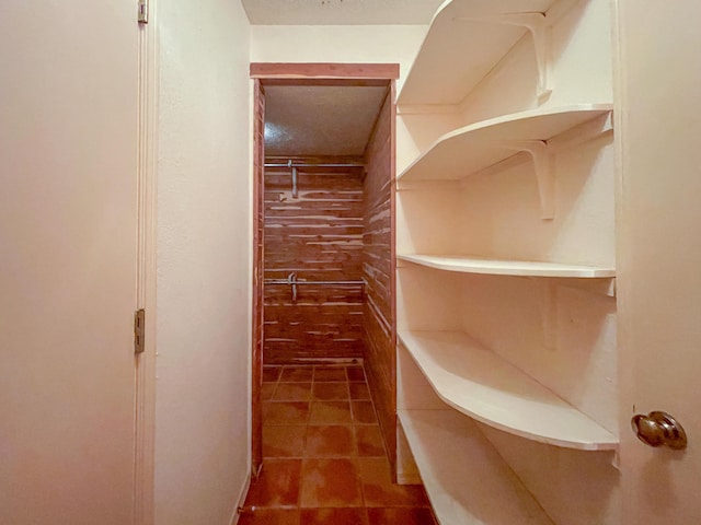 walk in closet with tile patterned floors