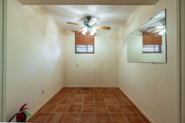 spare room featuring ornamental molding and ceiling fan