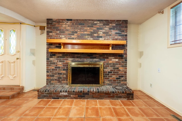 detailed view of a textured ceiling, a fireplace, and baseboards