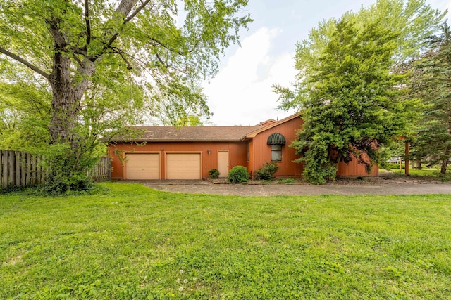 view of front of home with an attached garage and asphalt driveway
