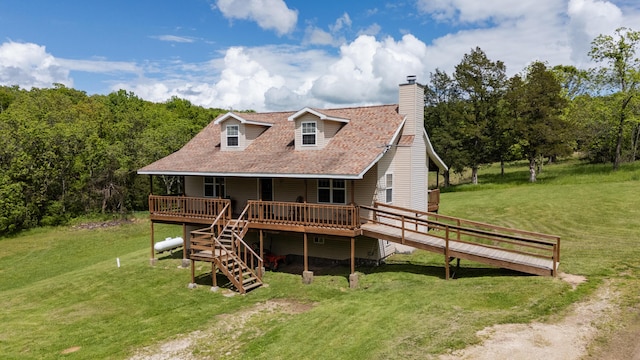 back of house with a wooden deck, a yard, a chimney, and stairs