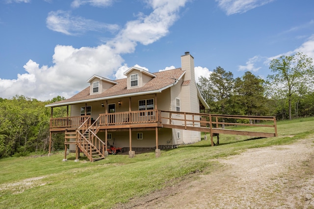 rear view of house featuring a lawn, a deck, a chimney, and stairs
