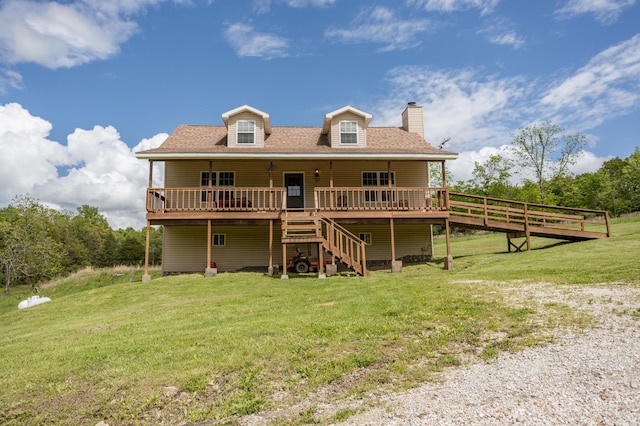 rear view of house featuring a lawn, a wooden deck, stairs, a chimney, and a shingled roof
