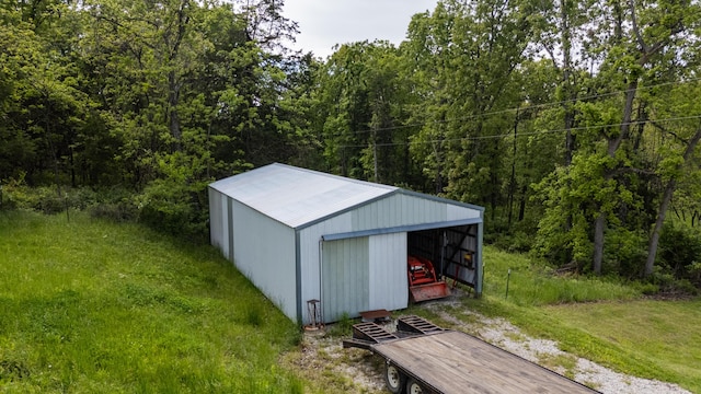 view of pole building with a view of trees