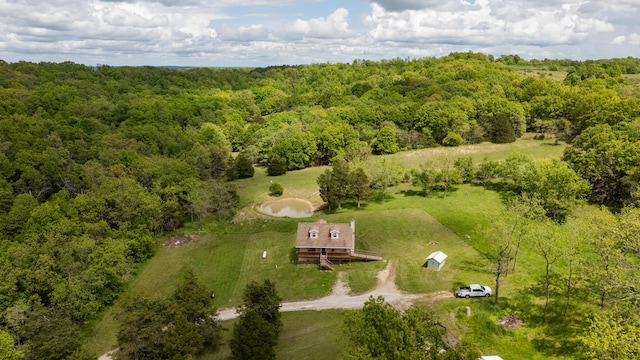 view of subject property with a forest