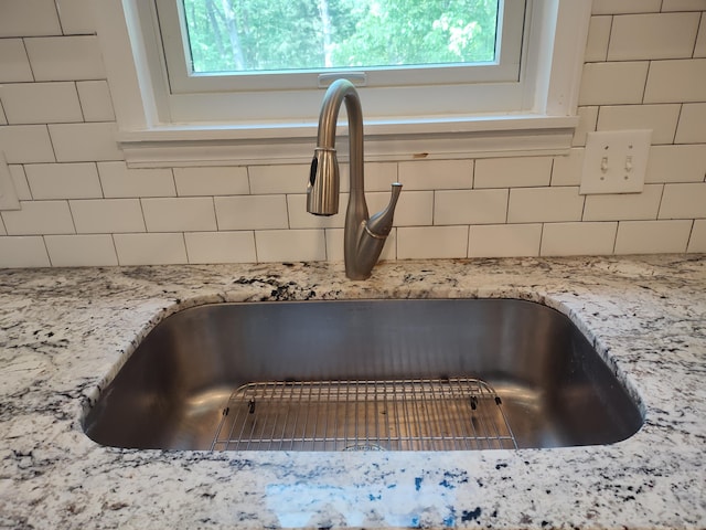 4181 S 105th Rd, Bolivar, MO 65613 - kitchen view of a sink, decorative backsplash, and light stone countertops