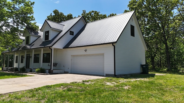 4181 S 105th Rd, Bolivar, MO 65613 - view of front of home with a front lawn, an attached garage, concrete driveway, and metal roof