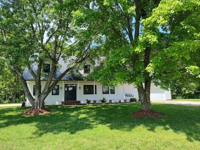 4181 S 105th Rd, Bolivar, MO 65613 - view of property hidden behind natural elements featuring a front lawn, a garage, and driveway