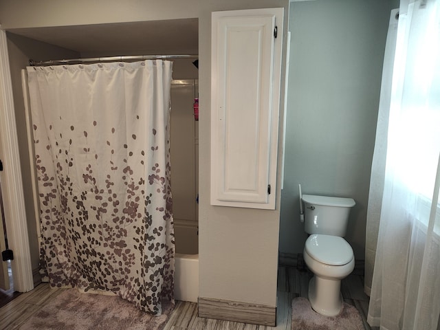 4181 S 105th Rd, Bolivar, MO 65613 - full bathroom featuring toilet, shower / bath combo with shower curtain, and wood finished floors