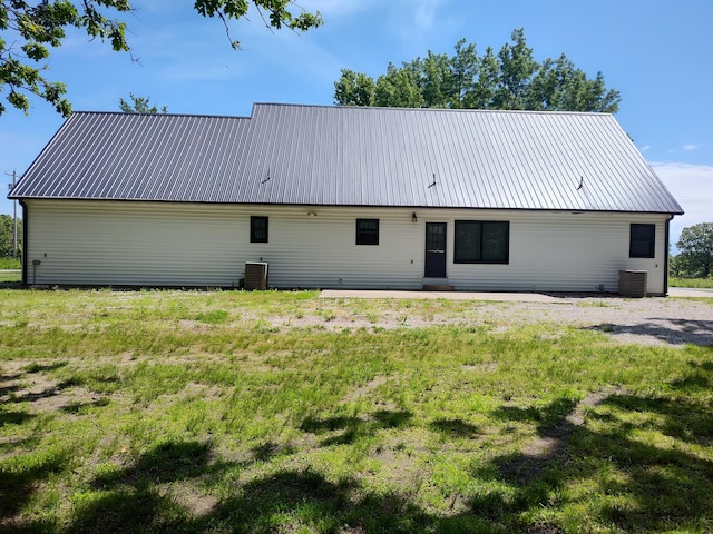 4181 S 105th Rd, Bolivar, MO 65613 - rear view of house with central AC, metal roof, and a yard