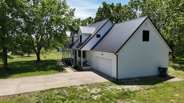 4181 S 105th Rd, Bolivar, MO 65613 - view of home's exterior featuring driveway, a lawn, an attached garage, and metal roof