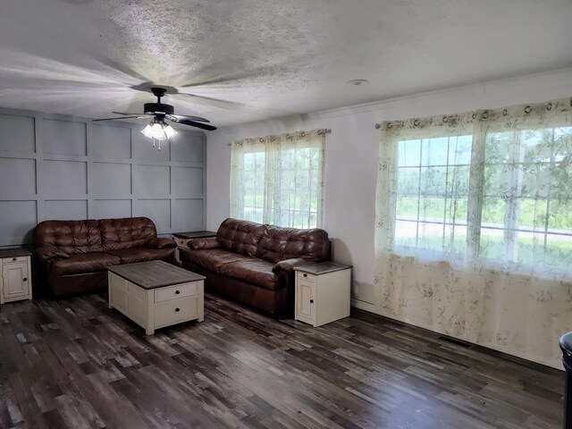 4181 S 105th Rd, Bolivar, MO 65613 - living area with dark wood finished floors, ceiling fan, and a decorative wall