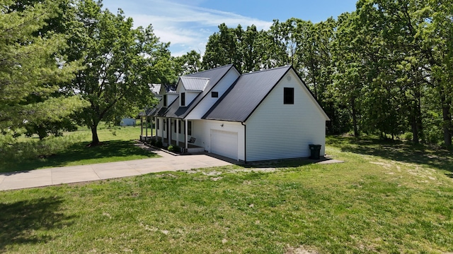 4181 S 105th Rd, Bolivar, MO 65613 - view of side of property with driveway, a yard, metal roof, an attached garage, and view of wooded area