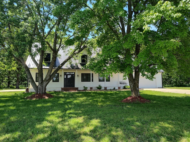 4181 S 105th Rd, Bolivar, MO 65613 - view of property hidden behind natural elements with driveway, a front yard, and a garage