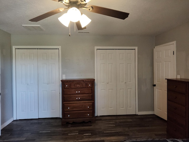 4181 S 105th Rd, Bolivar, MO 65613 - unfurnished bedroom with multiple closets, dark wood-type flooring, and baseboards