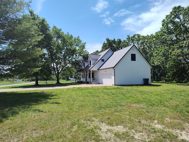 4181 S 105th Rd, Bolivar, MO 65613 - view of side of home with a lawn, metal roof, concrete driveway, and an attached garage