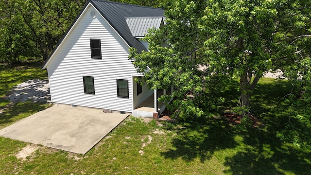 4181 S 105th Rd, Bolivar, MO 65613 - back of house featuring a patio, a lawn, and metal roof