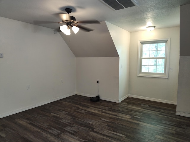 4181 S 105th Rd, Bolivar, MO 65613 - additional living space with dark wood finished floors, ceiling fan, baseboards, lofted ceiling, and a textured ceiling