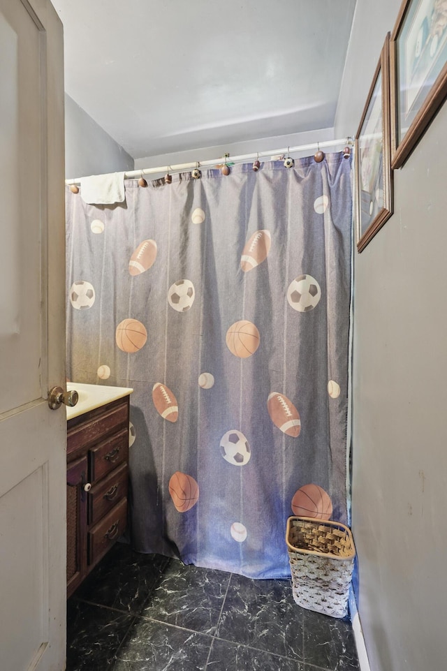 1014 Sycamore, Carthage, MO 64836 - full bathroom with marble look tiles, vanity, and a shower with curtain