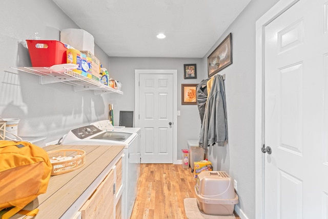 laundry room with separate washer and dryer, light wood-style flooring, baseboards, and recessed lighting
