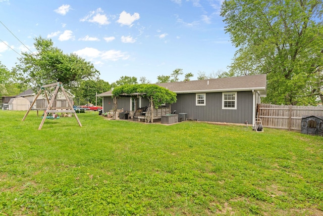 back of property featuring a playground and central AC unit