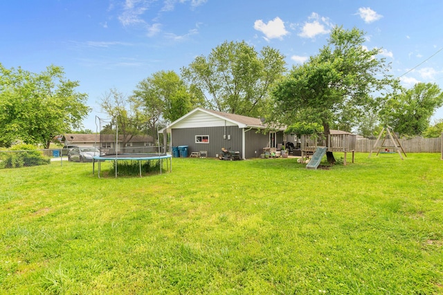 view of yard featuring a trampoline and a playground