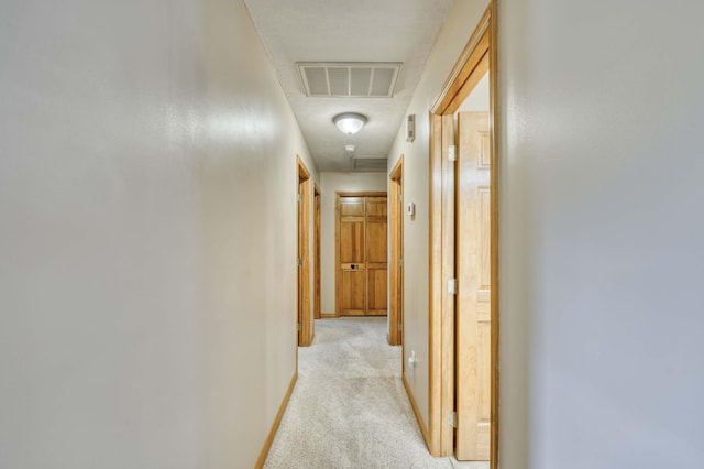 corridor with light colored carpet and baseboards